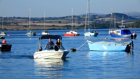 A-Small-Motorised-Boat-Traveling-Along-the-River-Tamar-in-Saltash-Between-Devon-and-Cornwall-on-a-Summers-Day