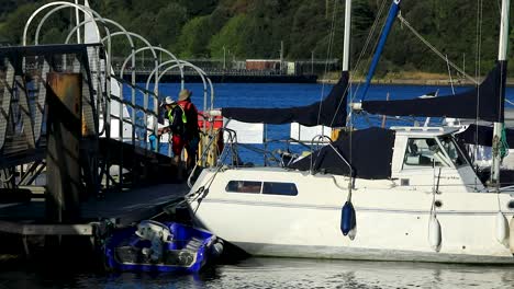 Two-Men-On-the-Saltash-Pontoon-with-their-Boats-on-the-River-Tamar-Between-Devon-and-Cornwall