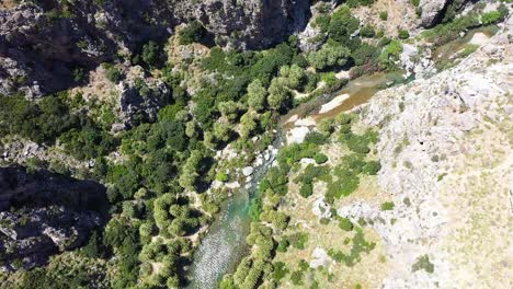 Drone-flight-over-a-beautiful-valley-with-a-river-that-flows-into-the-sea-in-Kreta,-greece