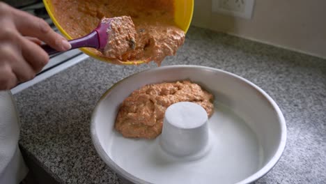 Baker-Pouring-Carrot-Cake-Dough-Mixture-On-The-Cooking-Mold