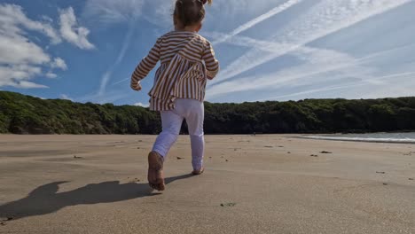 Young-toddler-runing-on-the-beach-follow-shot