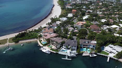 Beautiful-Housing-Along-the-Waters-of-Florida-with-Swimming-Pools-and-Yachts-from-an-Aerial-Drone-Shot-over-the-Town