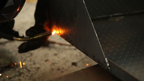 Welder-working-on-a-small-specific-area-of-heavy-metal-to-connect-for-the-best-result-possible