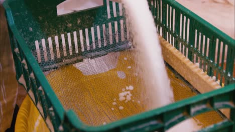 Pouring-dry-powder-paraffin-trough-a-mesh-in-slow-motion