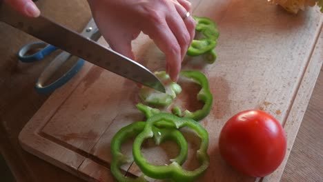 Cook-preparing-veggies-to-cook-vegan-burgers-with-green-pepper-in-4k-slow-motion