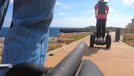 Tourists-ride-a-Segway-scooter-along-the-coast-of-Cala-Torta-Mallorca