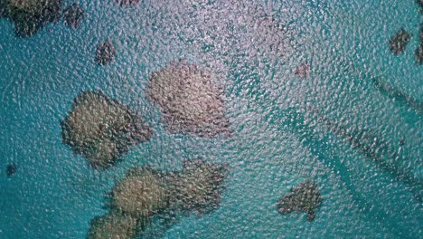 Aerial-fly-over-of-clear-blue-ocean-water-in-Tonga