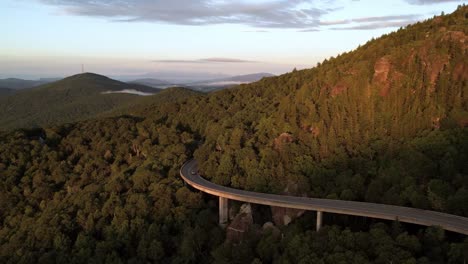 Car-on-the-viaduct-headed-west-at-sunrise-below-grandfather-mountain-nc