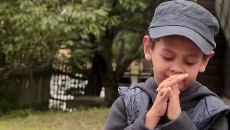Little-boy-praying-to-God-with-hands-together-stock-footage-1