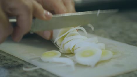 Cutting-vegetables-with-a-sharp-knife,-details-of-a-leek