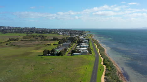 AERIAL-Australian-Coastline-With-Green-Fields-and-Houses-On-A-Sunny-Day