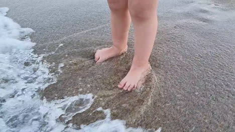 Sea-waves-splashing-baby-legs-on-the-sandy-beach