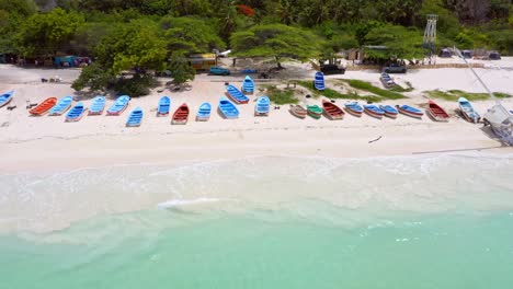 Fisherman's-Boats-And-A-Sailboat-Lined-Up-In-The-Beach-Sand-Of-Pedernales-In-Dominican-Republic