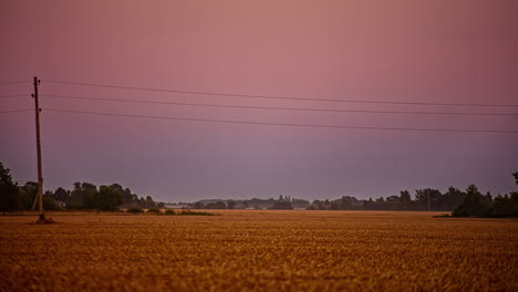 Sunset-to-nighttime-with-a-super-moon-rising-over-farmland---time-lapse