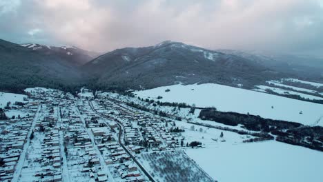 High-Tatras-high-mountain-town-covered-with-white-snow,-winter-holidays,-aerial