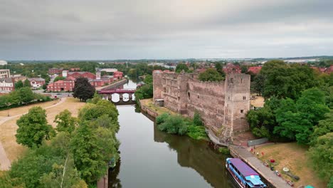 A-crane-shot-on-a-drone-rising-above-the-River-Trent-looking-at-Newark-Castle