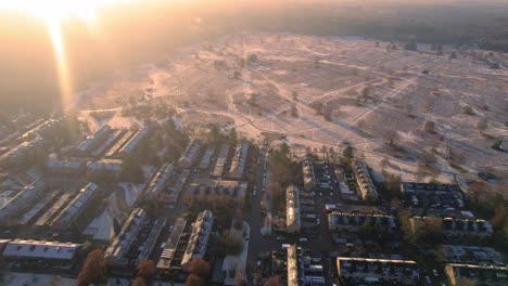Groevenbeekse-heide-suburbs-real-estate-area-by-park-in-winter,-sunset,-aerial