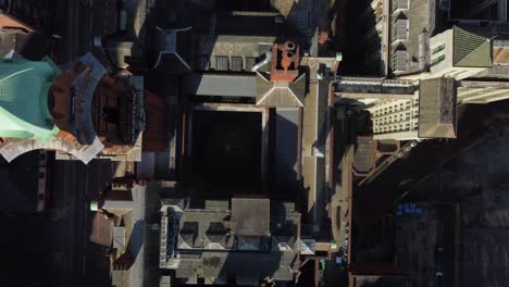 Aerial-drone-flight-over-the-Kimpton-Hotel-on-Oxford-Road-in-Manchester-City-Centre-giving-a-birdseye-view-of-the-Refuge-Building-rootops-below
