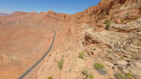 FPV-drone-flying-close-to-red-rock-sandstone-cliffs-of-Arizona-in-Antelope-Pass-Vista