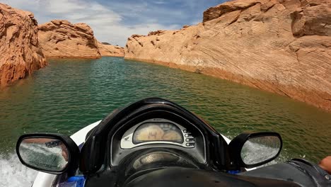 Point-of-view,-person-jet-skiing-through-red-canyon-slots-of-Lake-Powell