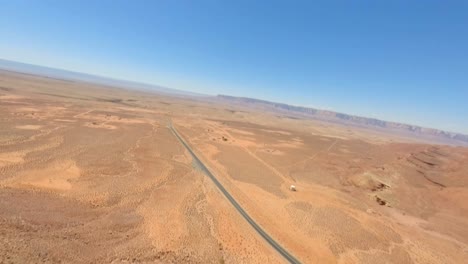 FPV-drone-flying-down-red-sandstone-cliffs-of-Antelope-Pass-Vista,-Arizona