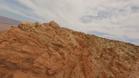 Aerial-FPV-flying-through-red-sandstone-rock-cliff-formations-in-Arizona
