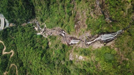 Directly-above-a-waterfall-that-leads-to-walking-trails-and-a-muddy-river
