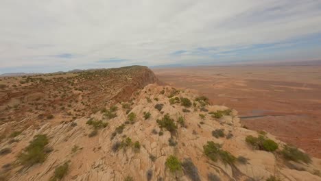 FPV-drone-flying-through-sandstone-canyon-rock-cliffs-in-Antelope-Pass-Vista,-Arizona