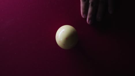 Man-hitting-cue-ball-on-pool-table