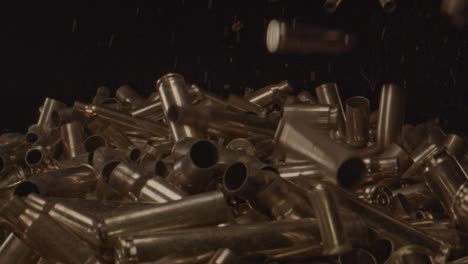 Stunning-slow-motion-of-spent-shell-casings-falling-on-a-pile-of-bullet-shells