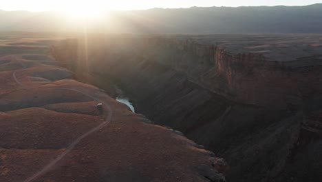 Aerial,-mini-camper-van-on-a-road-trip-parked-by-Marble-Canyon-in-Arizona-during-sunset
