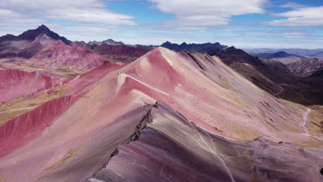 Forward-aerial-shot-of-mountains-with-red-ore-on-the-seven-colored-mountain-in-Vinicunca