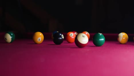Slow-motion-Man-hits-cue-ball-and-breaks-ball-rack-on-the-pool-table