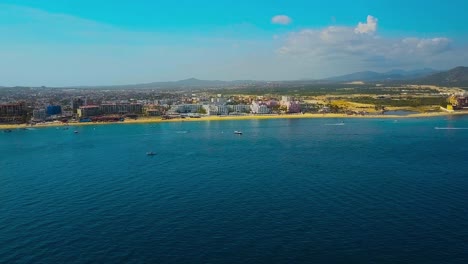 Drone-zoom-in-cinematic-shot-of-resort-and-buildings-in-Cabo-San-Lucas,-Mexico