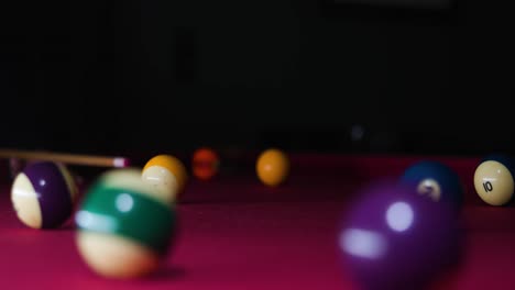 Man-hits-cue-ball-and-tries-to-hit-the-solid-ball