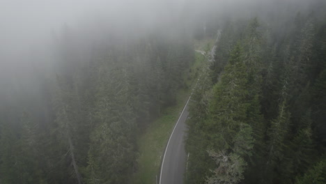 Car-drives-up-Passo-di-Giau-in-misty-conditions