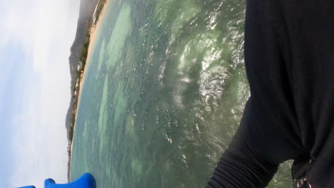 POV-first-person-view-of-person-kite-surfing-on-ocean-doing-a-big-jump