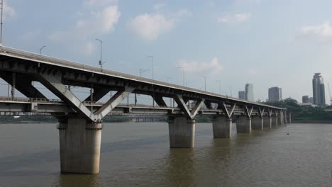 Cheongdam-Bridge-over-river-Han-and-Seoul-metro-train-line-7-going-to-Gangnam-district,-South-Korea