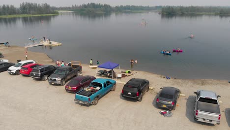 4K-Drone-Video-of-Swimmers-and-Paddle-Boarders-on-Cushman-Lake-in-Fairbanks,-AK-during-Summer-Day