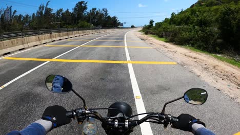 Riding-a-bike-over-yellow-lines-in-southern-Vietnam,-POV-shot