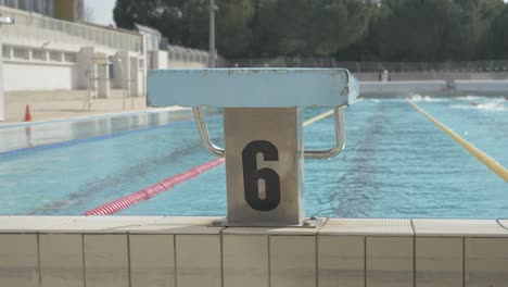 Diving-board-at-the-montpellier-swimming-pool-with-swimmers-in-the-background