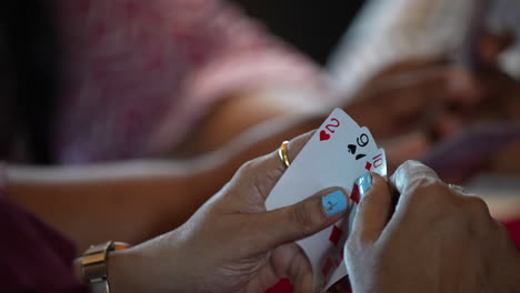 One-woman-holding-3-cards-for-playing-in-cruise-Singapore-poker