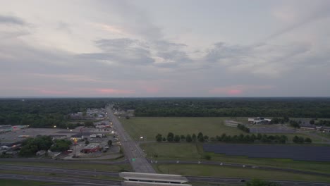 Aerial-drone-forward-moving-shot-over-highway-connecting-narrow-roads-during-evening-time-after-sunset