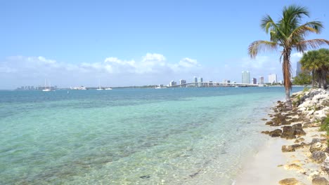A-postcard-from-Miami,-beach,-white-sand,-ocean-crystal-water-and-the-skyline-as-background