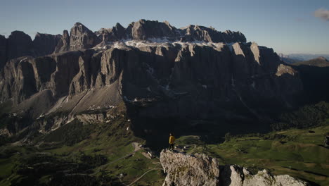Alpinist-stands-on-Gan-Cir-peak,-view-of-dramatic-Dolomites
