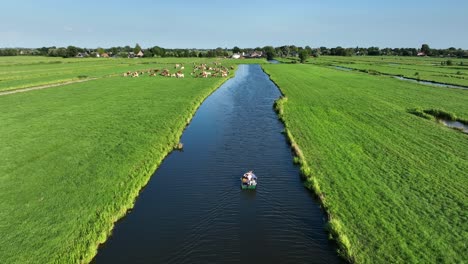 Aerial-Drone-Shot-of-Small-Boat-on-a-Dutch-Polder-Waterway