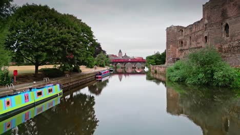 A-drone-moves-along-the-river-Trent-in-Newark,-Nottinghamshire,-England
