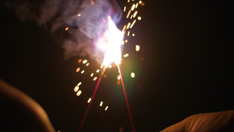 A-guy-and-girl-holding-sparklers-on-the-4th-of-July