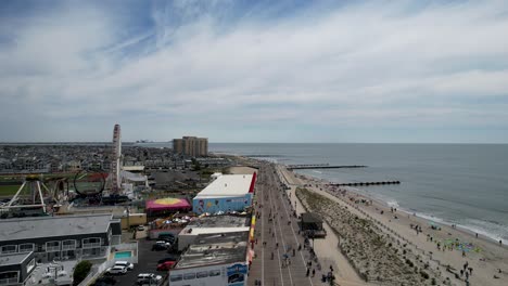 Aerial-shot-over-the-Ocean-City,-New-Jersey-boardwalk-on-a-warm-sunny-day