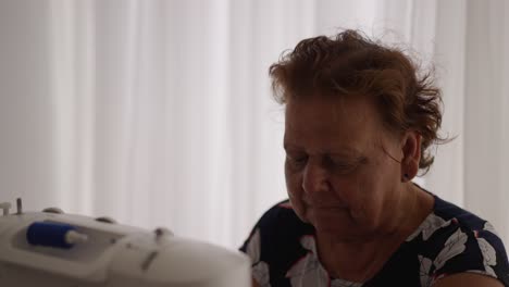 Grandmother-using-sewing-machine-for-leisure-time-hobby